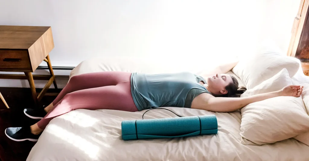 A woman sleeping peacefully after exercising, illustrating the positive impact of exercise and sleep quality by promoting relaxation and reducing stress.